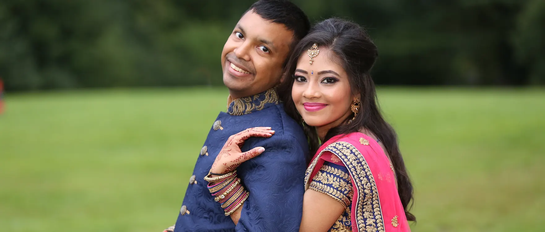 Bride and groom together in an open field