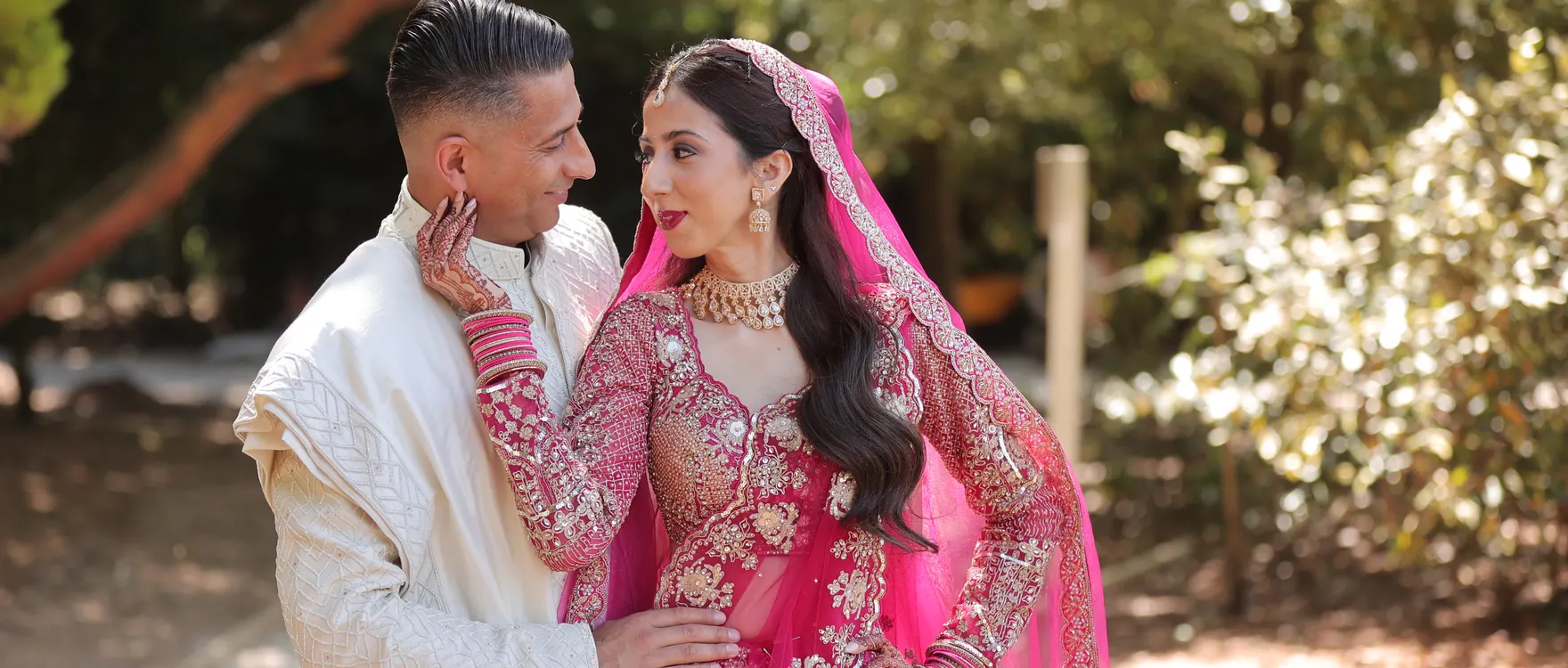 Bride and groom in a garden, groom in a white sherwani