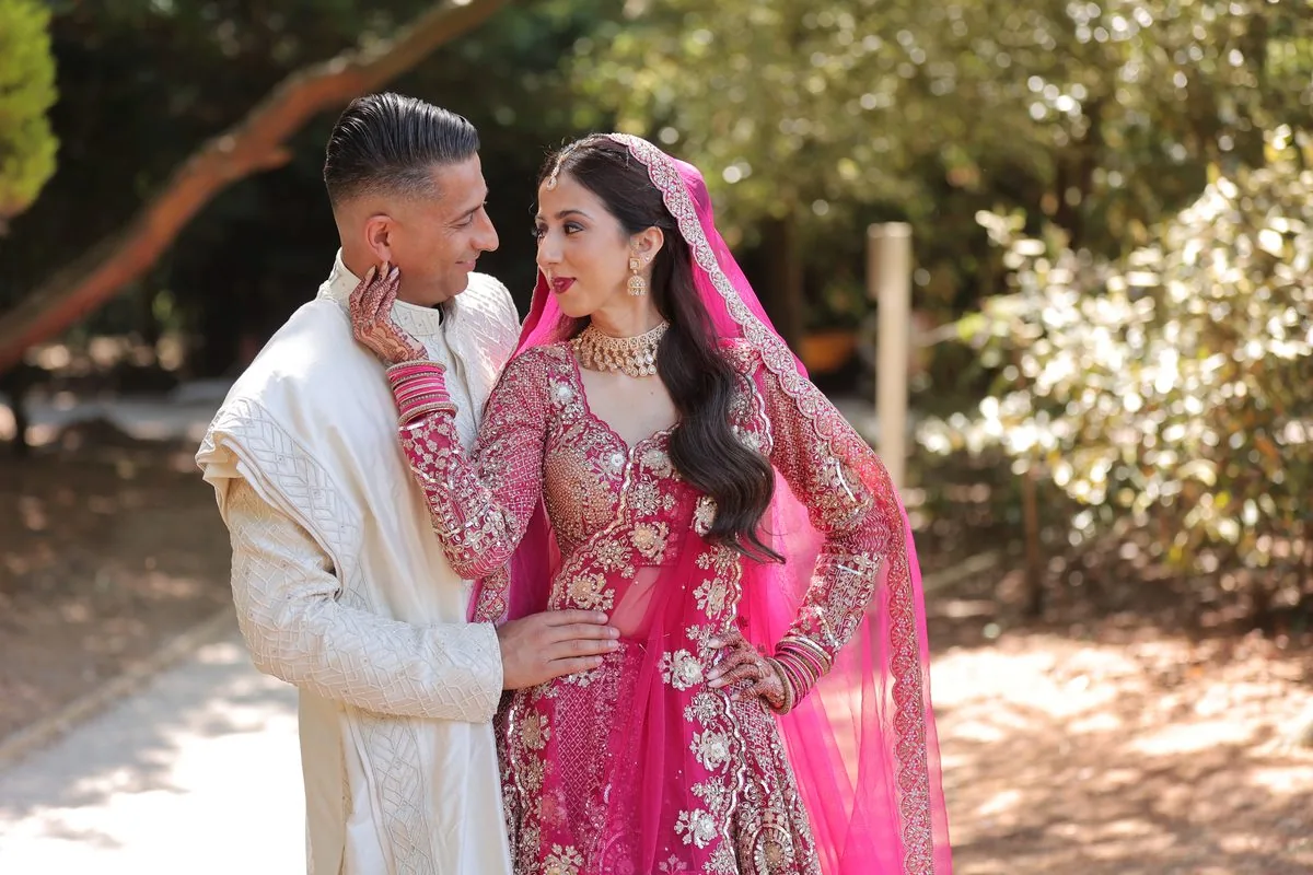 A second photographer capturing guests' reactions during a ceremony