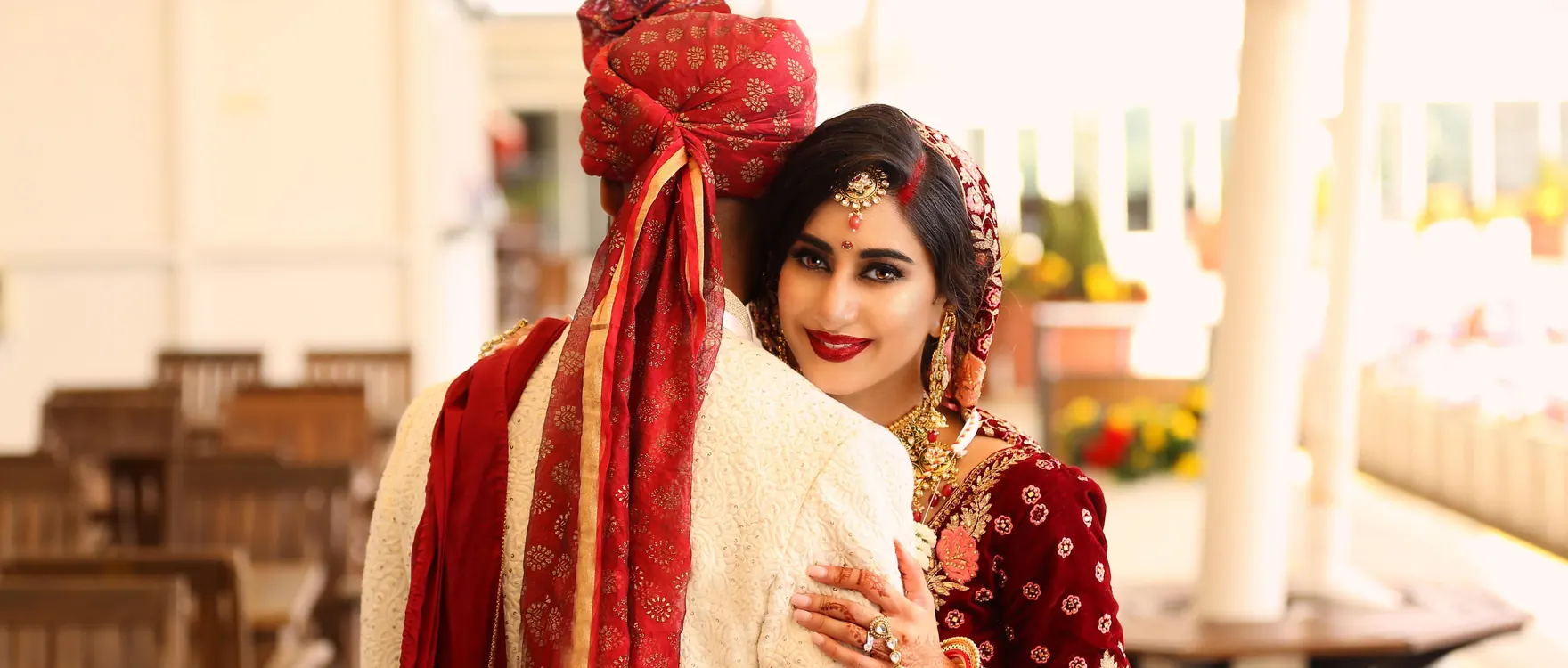 Bride and groom seated together, groom in a sehra turban