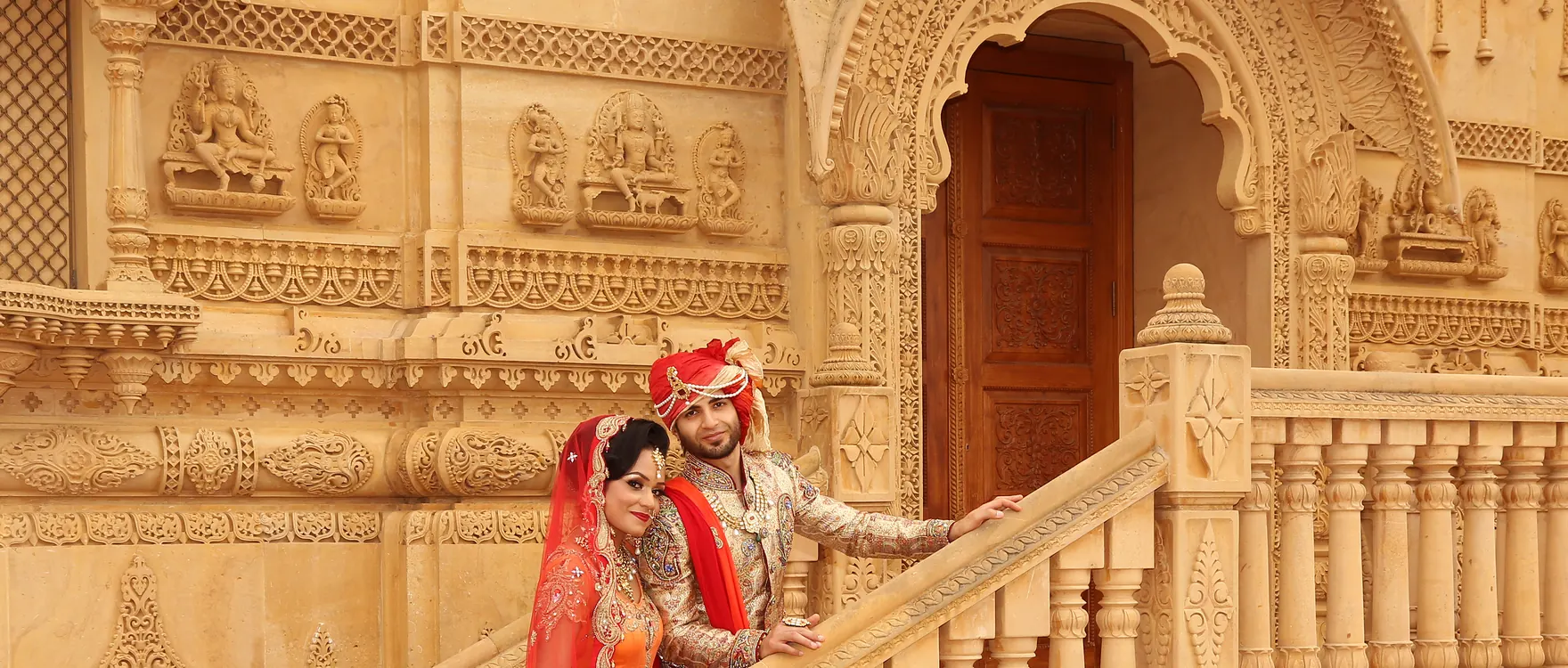 Bride and groom on a carved stone staircase