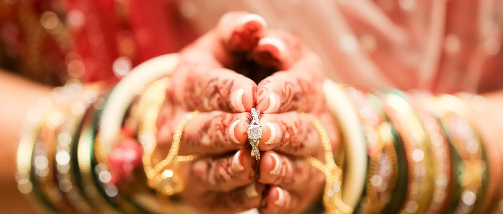 Close-up of bridal bangles, mehndi and a ring