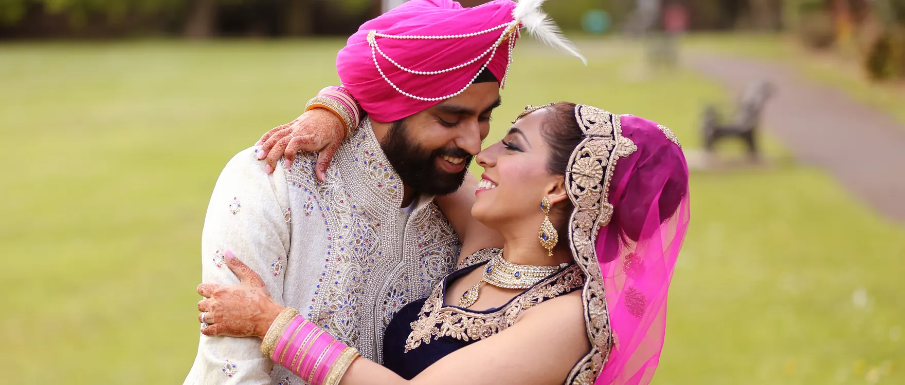 Bride and groom in a park, groom in a turban and kalgi