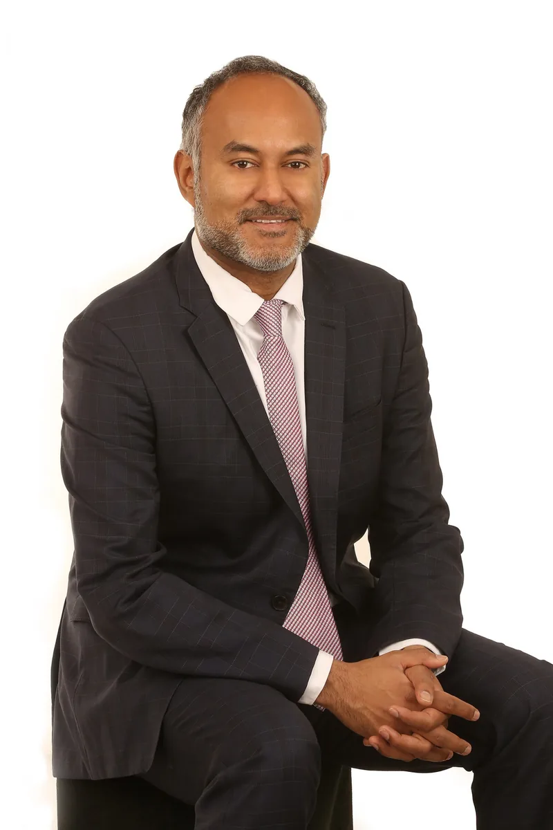 Head and shoulders studio portrait on a plain backdrop