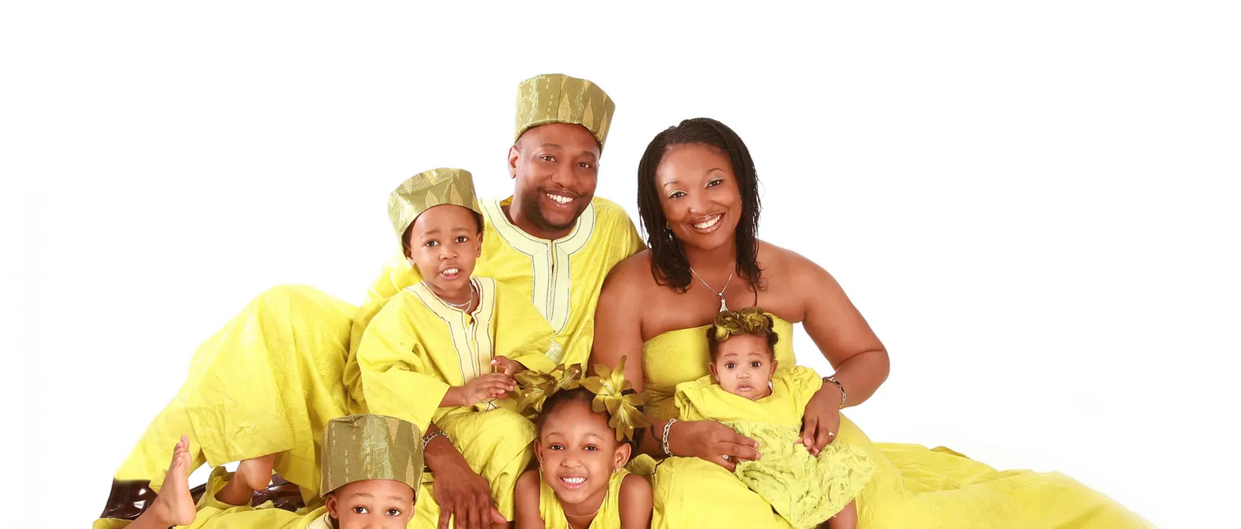 Family of five in matching yellow outfits, studio group portrait