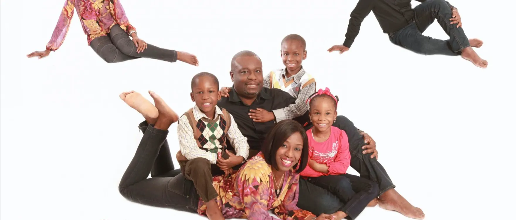 Large extended family in small groups across the studio floor