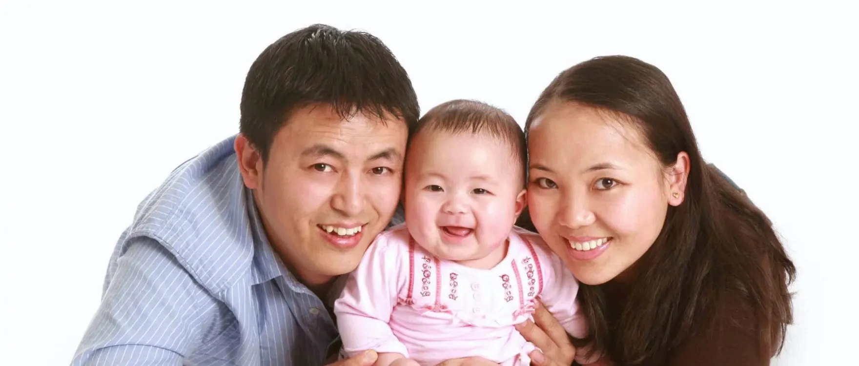Parents lying on the studio floor with their baby between them