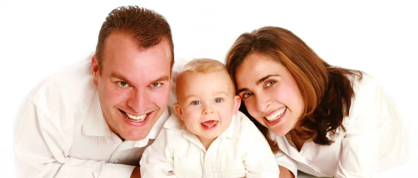 Parents lying on the studio floor with their toddler between them