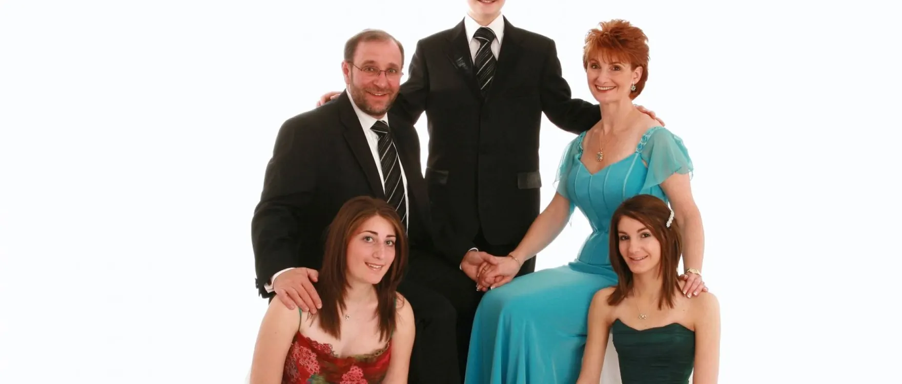 Family of five in evening wear, studio group portrait